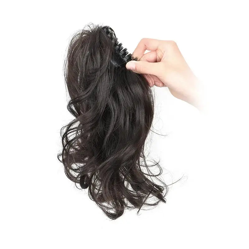 Synthetic 12Inch Ponytail Claw Clip Ponytail Extensions Short Curly Ponytail Ladies Black Brown Blonde Hair Clip for Women held in hand.